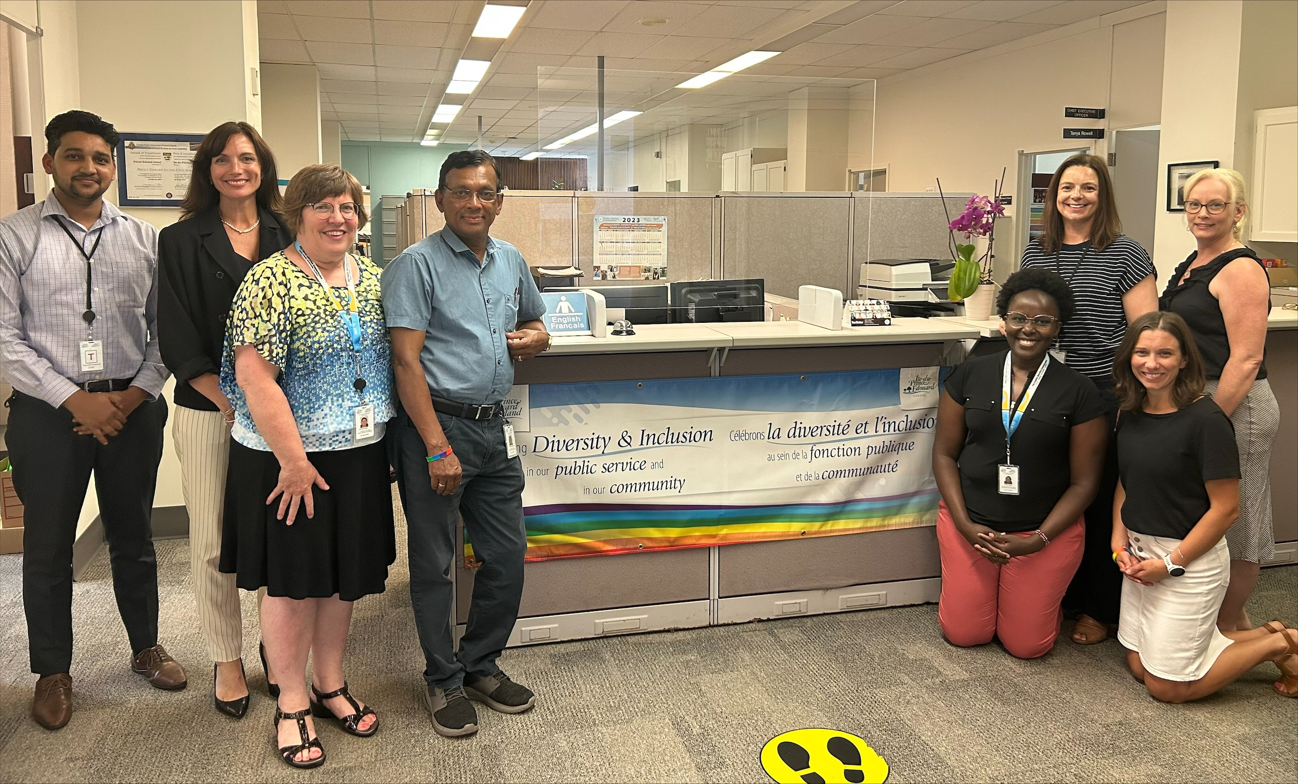 "PSC Employees pictured for Pride Week 2023. L-R: Sahil Kanwar, Tanya Rowell, Anne Marie Abrey, Thilak Tennekone, Sarah Muthee, Marilee Miller, Maribeth Vos, Pam Wynne"